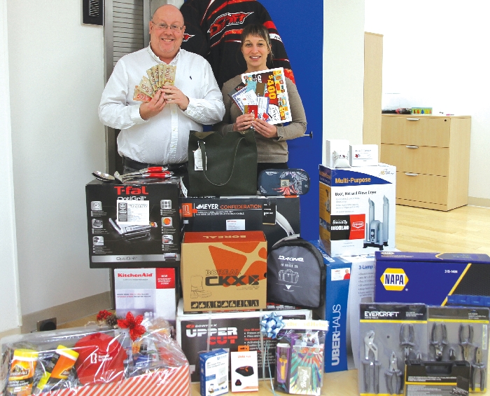 Kara Kinna and Kevin Weedmark with some of the prizes from the World-Spectator/Plain and Valley Prize Vault that will be won as part of the World-Spectator Christmas Giveaway, as well as the $15,000 grand prize.